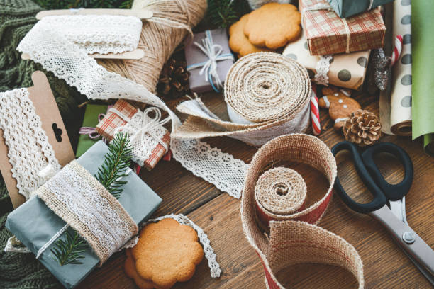 istock hands wrap christmas presents in craft paper 2173573144