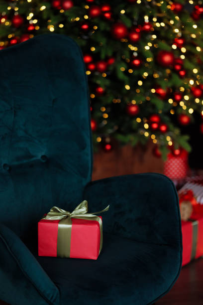 istock A green chair with a one red gift box on it 2173582982