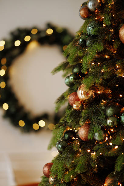istock A Christmas tree with green and gold ornaments is lit up 2173584136