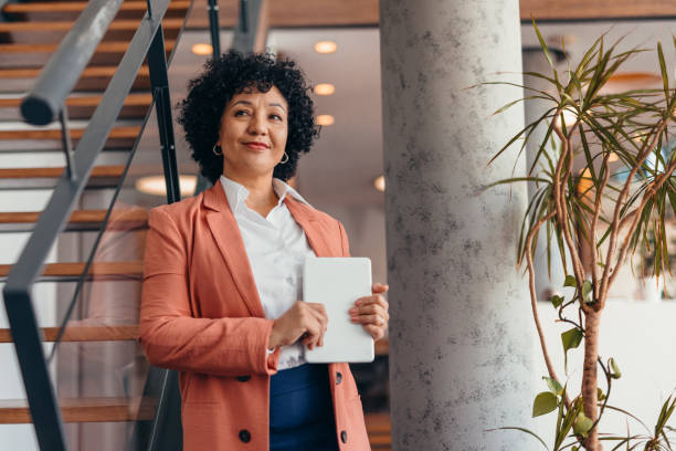 istock Confident businesswoman holding tablet in modern office setting 2173587962