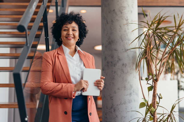 istock Confident businesswoman holding tablet in modern office setting 2173587968
