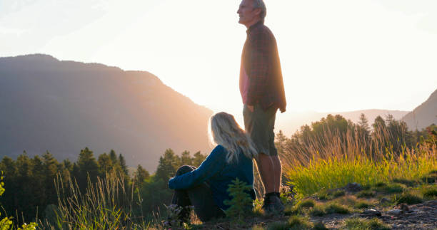 istock Mature couple watch sunset over mountains 2173588046