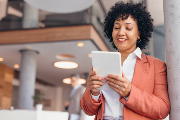 istock Professional business woman using tablet in modern office interior. 2173588098