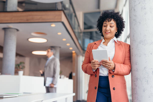 istock Professional business woman using tablet in modern office interior. 2173588103