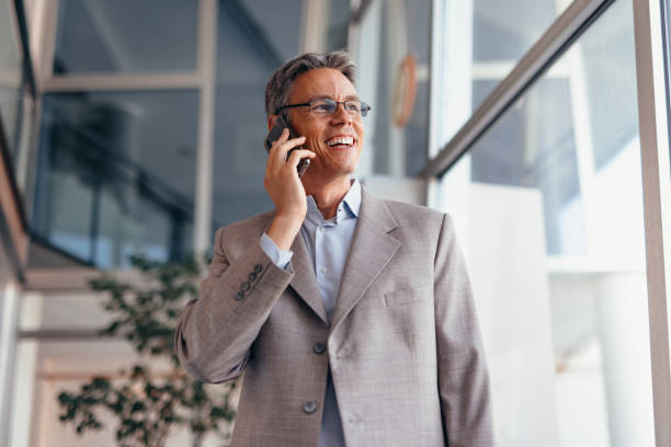 istock Businessman talking on phone and holding documents confidently in the office 2173588138