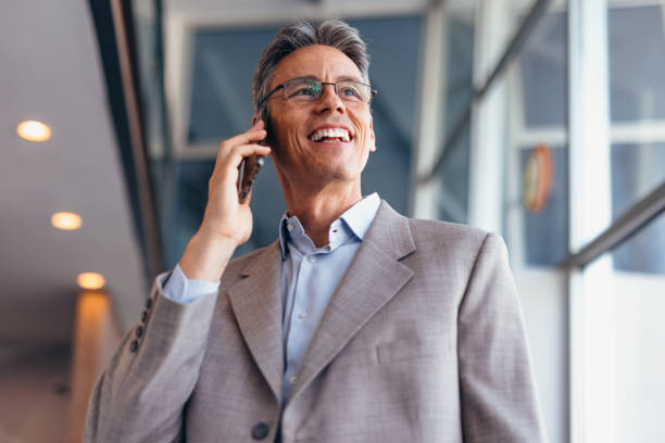 istock Businessman talking on phone and holding documents confidently in the office 2173588199