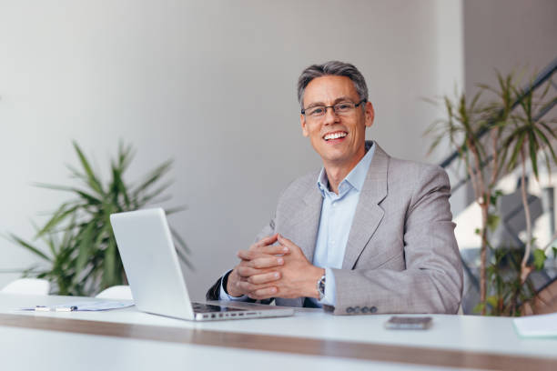 istock Business professional smiling confidently at desk with laptop 2173588247