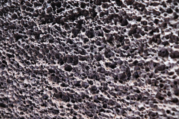 A pebble made from porous volcanic rock found in Iceland, isolated on white