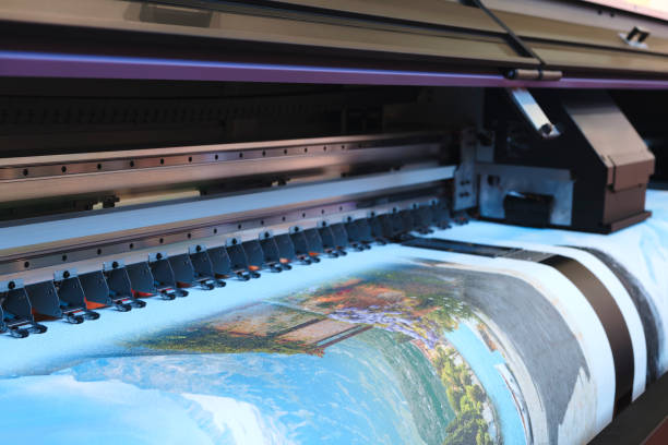 istock A printer is printing a picture,  printer is black and silver. The image is blurry 2173605414