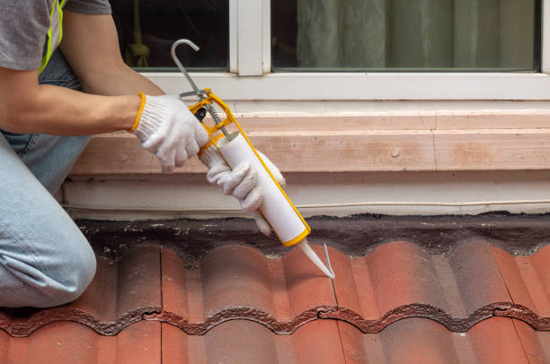 istock Construction worker using silicone sealant adhesive to fix crack of the old tile roof. 2173632122