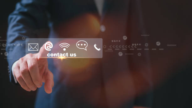 istock Contact us or Customer support hotline people connect. Businessman pointing at a virtual screen contact icons email, address, live chat, internet wifi 2173640207