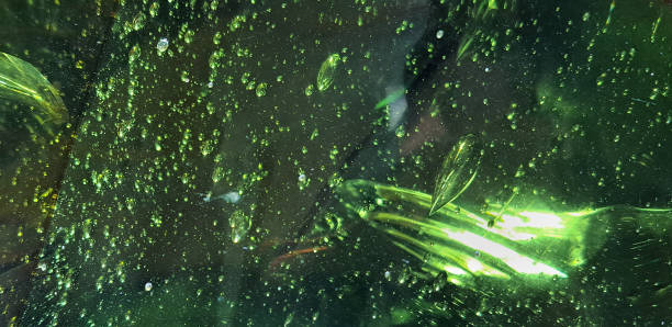 Close up of green emerald gemstone with its bubble and scratch texture. Seen the air bubbles and the solid content inside the gemstone with some scars, scratch, and natural marks inside of it. scuff marks photos stock pictures, royalty-free photos & images