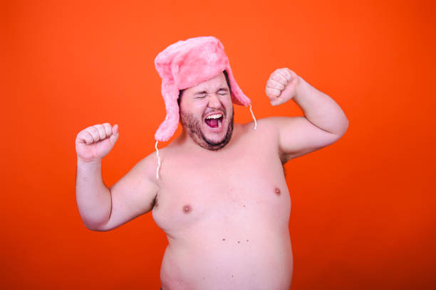 istock Joy and fun. Funny drunk adult man dancing in studio on orange background. 2173643900