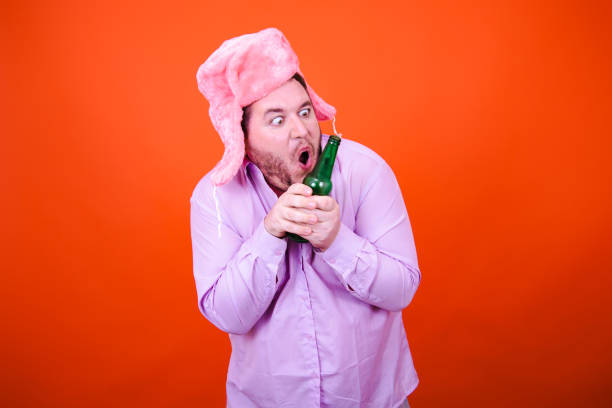 istock Joy and fun. Funny drunk adult man dancing in studio on orange background. 2173643978
