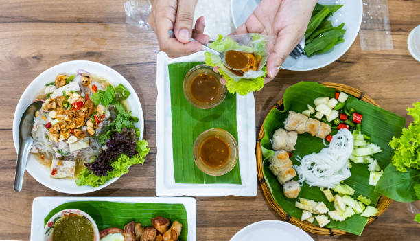 istock Top view of Hand holding Vietnamese Meatball Wraps (Nam Neung), focus selective 2173644580