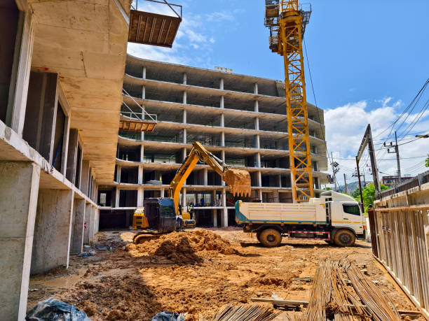istock Excavator loads ground into a dump truck at a construction site 2173645957