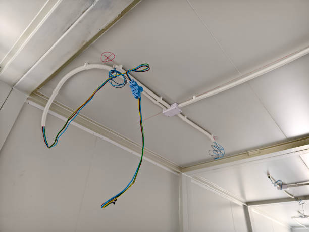 istock A collection of various wires is hanging down from the ceiling 2173648337