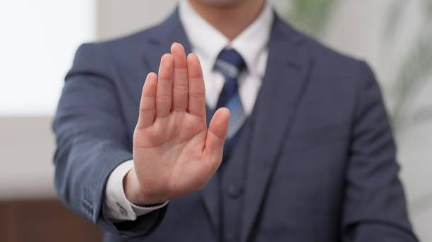 Hands of a businessman showing his palm stock photo