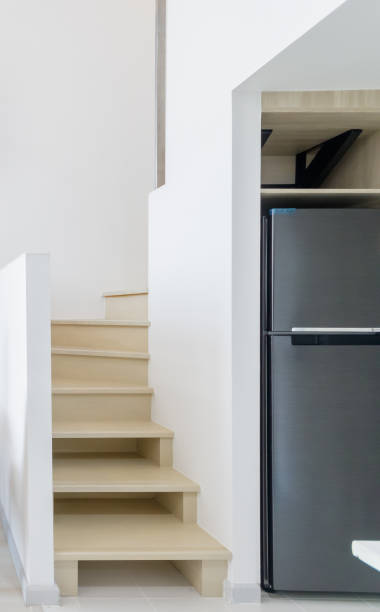 istock sleek refrigerator fitted under a staircase, maximizing space in a minimalist, modern home. 2173649977