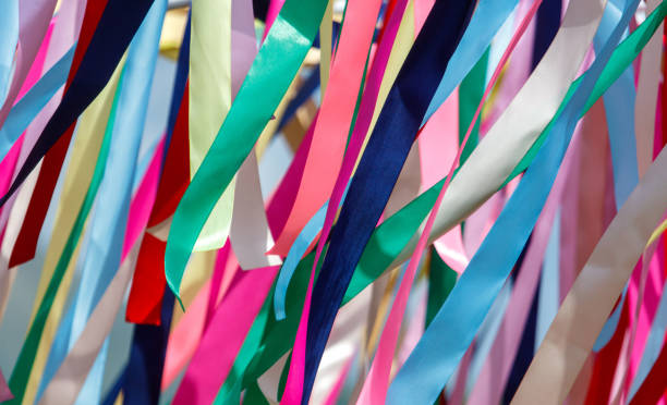 istock Multicolored festival ribbons flutter in the wind. Background 2173654022