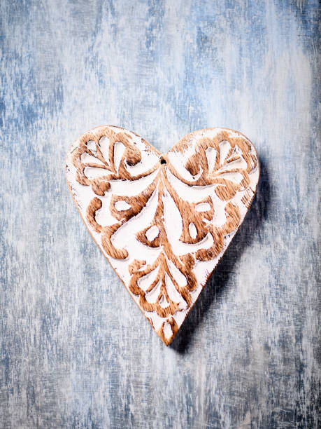 Wooden Heart (Christmas ornament) on bright background. Soft focus. Top view. Copy space.