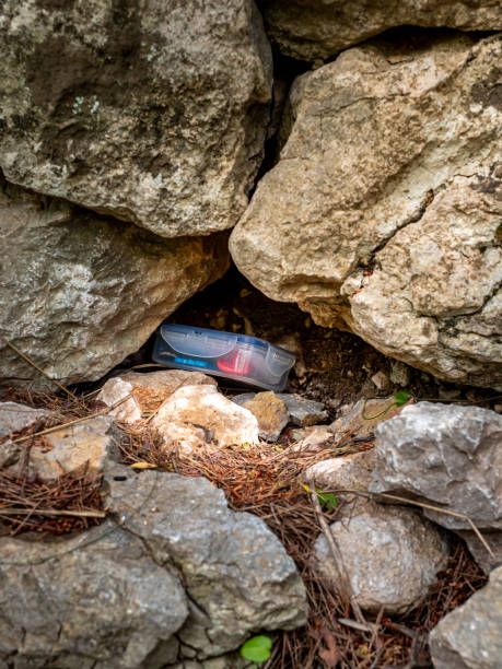 istock A common geocache plastic container hidden between rocks of a rural stone wall of Mallorca offers a typical geocaching experience, merging recreation and nature, appealing to geocaching enthusiasts. 2173662448