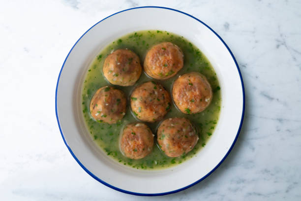 Fish meatballs with green parsley sauce. Top view table with decoration..