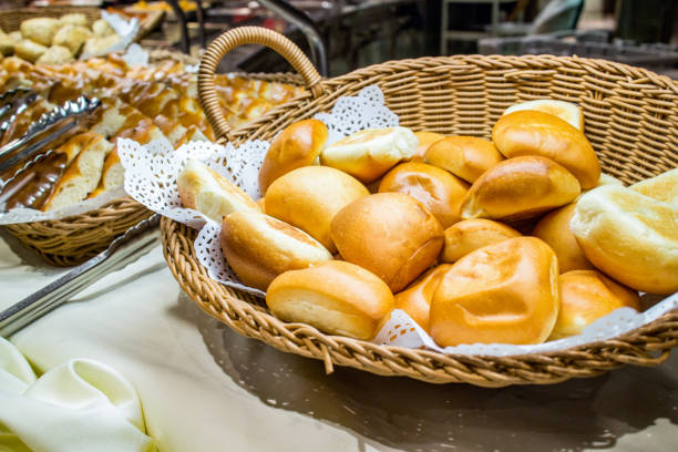 Closeup bread rolls in baking tin mold on wood background.