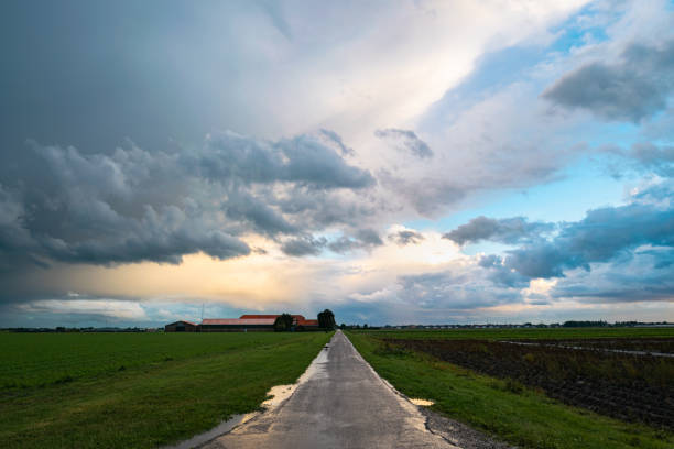 Dramatic image of a thunderstorm over a country road just before sunset.