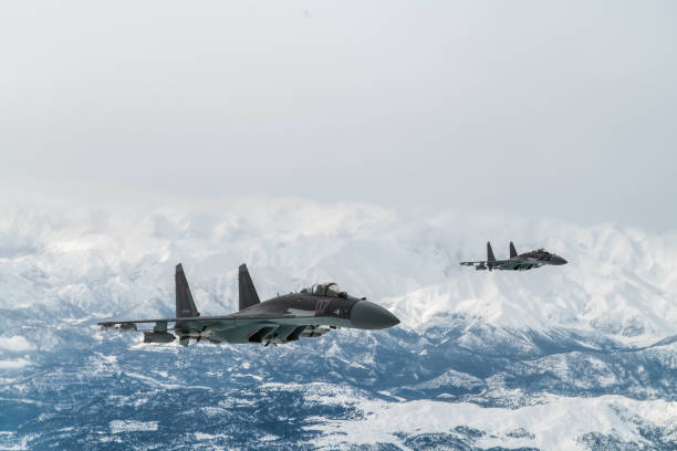 istock Jet fighters flying over snowcapped mountains. 2173670456