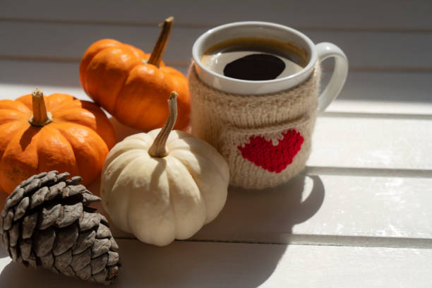 istock Coffee cup on wooden table with pumpkins 2173670511