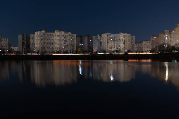 Night Skyline with lights on the evening lake, Kyiv, Ukraine. Urban landscape