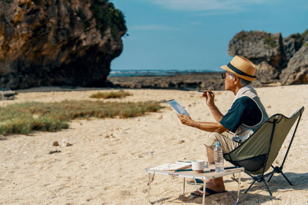 istock Senior man watercolor painting on a beach 2173679562