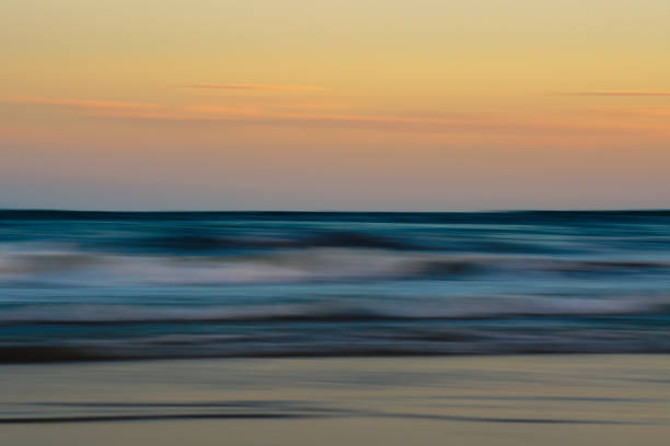 Gentle waves and pastel skies create a peaceful, abstract seascape.