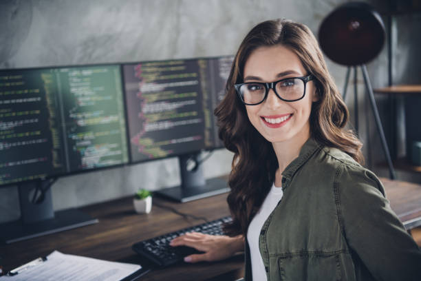 istock Portrait of cheerful intelligent manager lady toothy smile operating pc typing code workstation business center indoors 2173683181