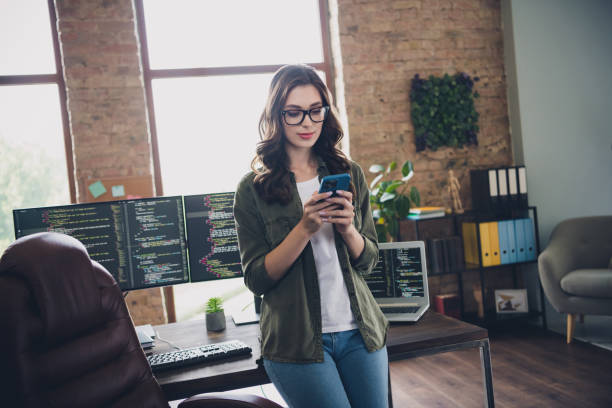 istock Photo of concentrated smart lady ceo engineer designer discusses issue operating system no wifi connection workstation modern room indoor 2173683291