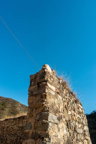 istock Ruined stone wall with blue sky background 2173685684