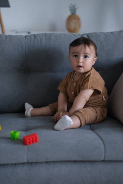 istock toddler playing with toys on sofa 2173690965