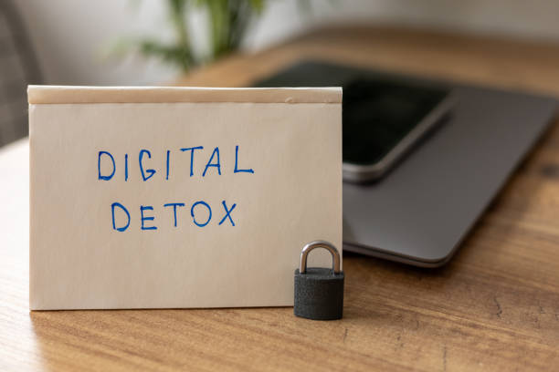 istock Simple note for digital detox placed on a wooden table with a locked phone nearby 2173690968
