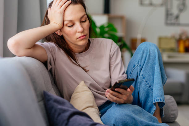 istock Female using smartphone at home internet watching videos, social networks 2173692171