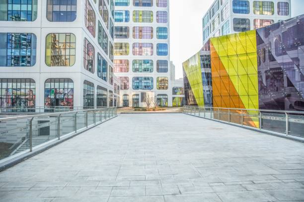 istock Modern empty pedestrian walkway with colorful glass buildings in background 2173692252