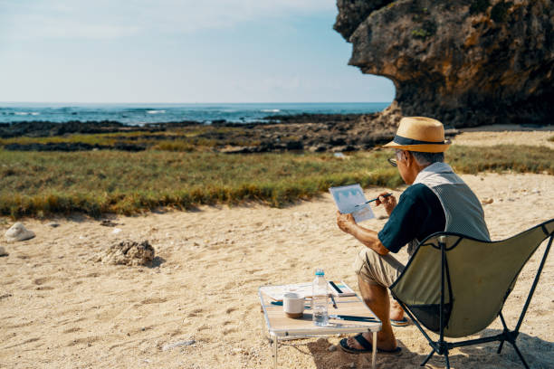istock Senior man watercolor painting on a beach 2173695241
