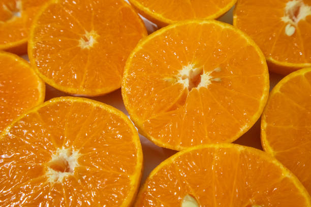 Fresh mandarin orange slices on a wooden table