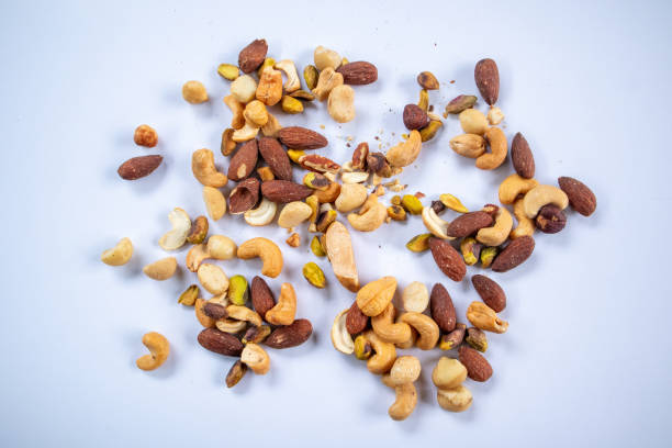 Mixed nuts on white background, snack on healthy fats and protein. Weight loss and keto diet ideas