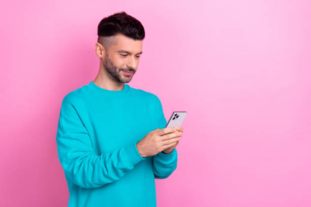 istock Portrait of nice positive person hold use telephone write post comment empty space isolated on pink color background 2173699498
