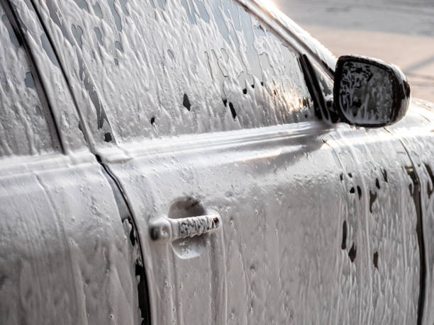 istock black car covered with a foam in a car wash 2173701489