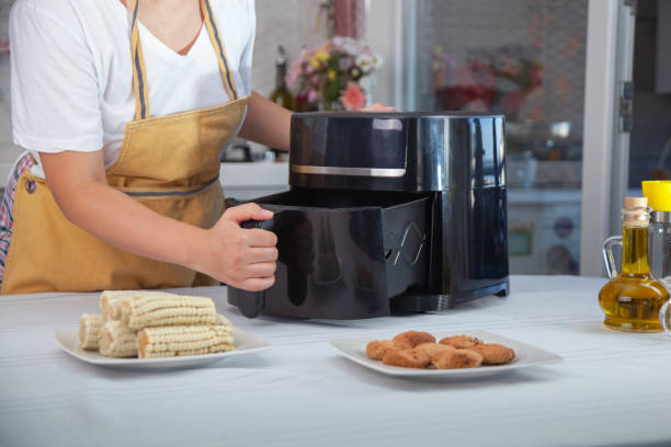 istock Woman using air fryer in the kitchen. 2173708701