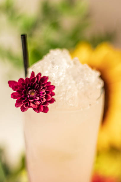 Flower Cocktail Vodka Gin Lychee Sunflower Roses Marble Background Close up garnish rose glassware