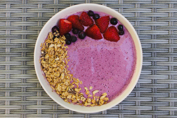 istock Purple Smoothie Bowl With Granola Top View 2173716395