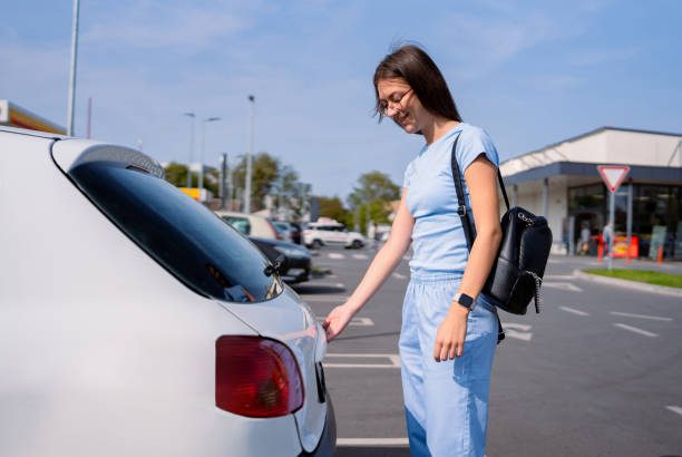 istock Person in light blue attire preparing car for journey. 2173720370